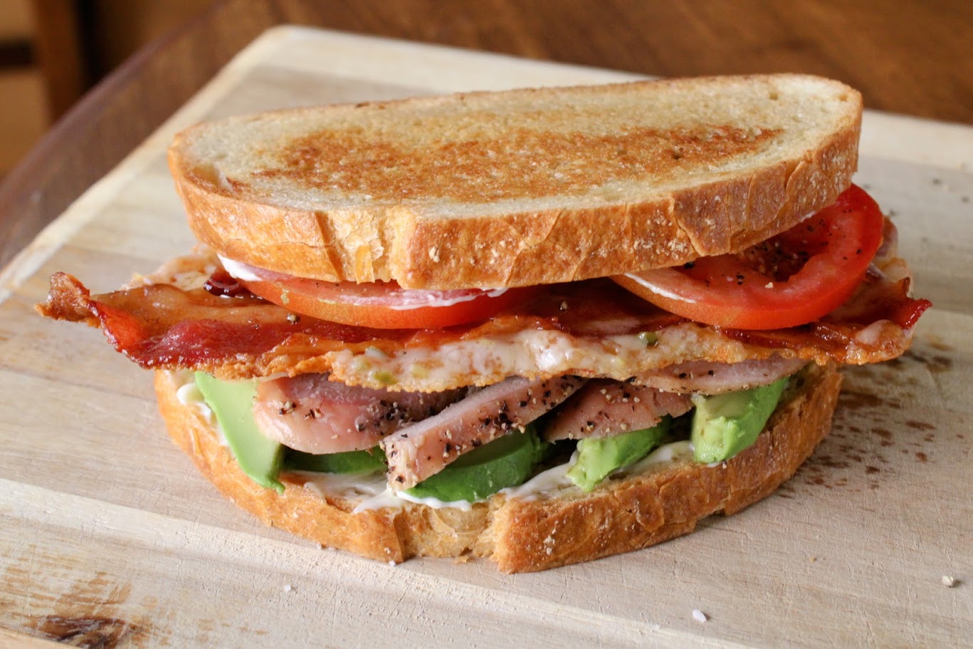 California club sandwich with a pepper Jack and bacon cheese skirt